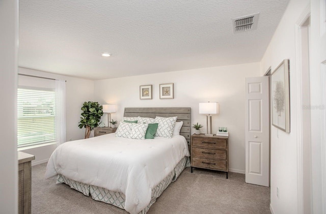 carpeted bedroom with a textured ceiling