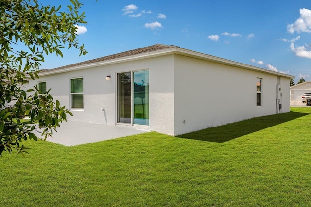 rear view of house featuring a lawn