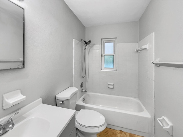 full bathroom featuring vanity, tiled shower / bath combo, and toilet