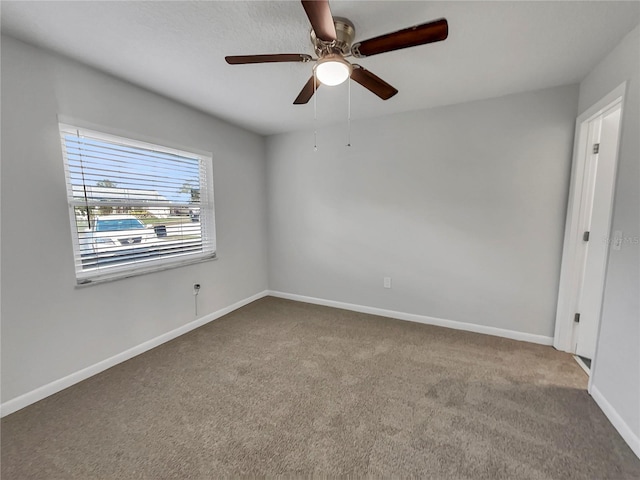 carpeted empty room featuring ceiling fan