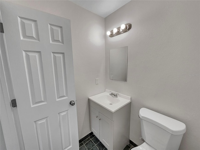 bathroom with tile patterned floors, vanity, and toilet