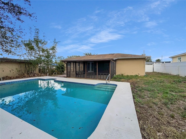 view of pool with a lawn and a sunroom