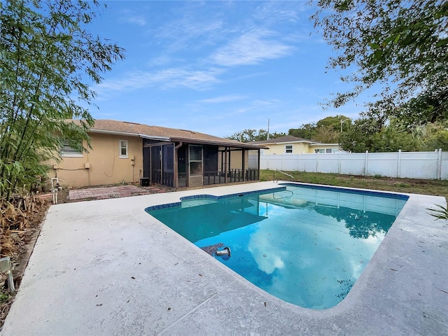 view of swimming pool featuring a sunroom and a patio