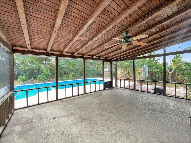 unfurnished sunroom featuring vaulted ceiling with beams, ceiling fan, wooden ceiling, and a wealth of natural light