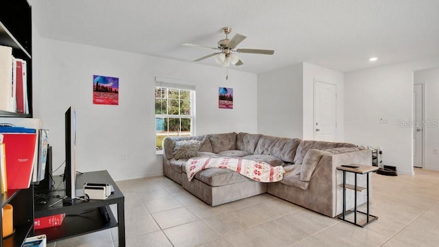 living room featuring light tile patterned floors and ceiling fan