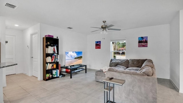 tiled living room with ceiling fan