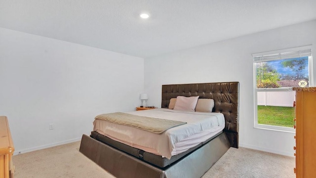 carpeted bedroom featuring multiple windows