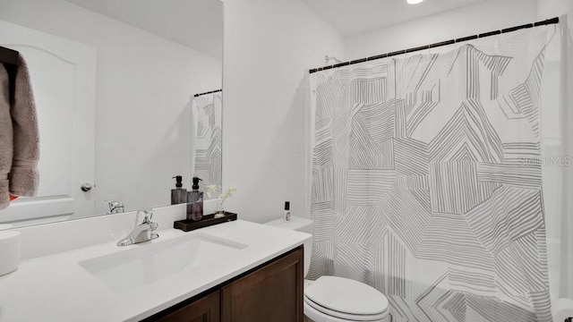 bathroom with a shower with shower curtain, vanity, and toilet