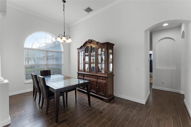 dining space with ornamental molding and a chandelier