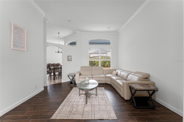 living room with a notable chandelier and crown molding