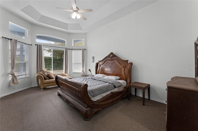 bedroom featuring carpet flooring, ceiling fan, and a raised ceiling