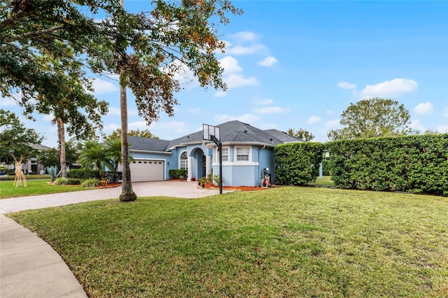 view of front of property with a front yard and a garage