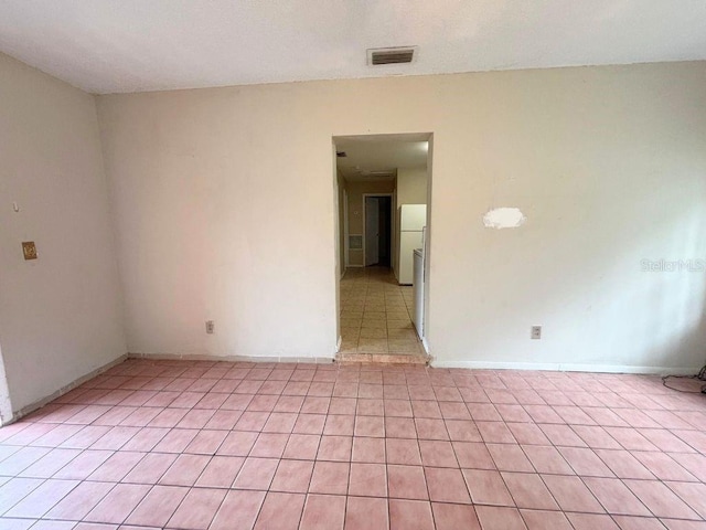 empty room with light tile patterned floors