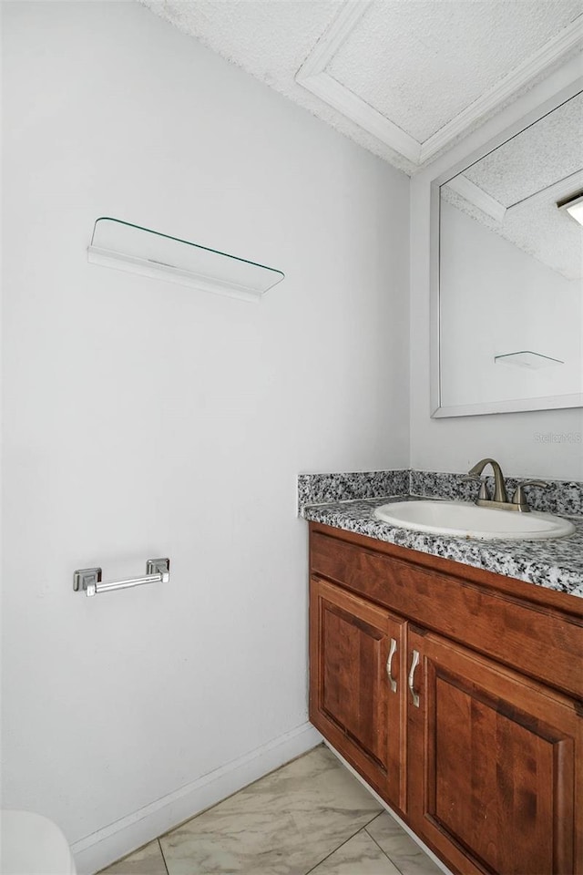 bathroom featuring a textured ceiling and vanity