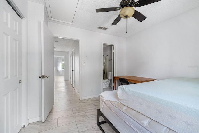 bedroom featuring ensuite bath, ceiling fan, a closet, and a textured ceiling