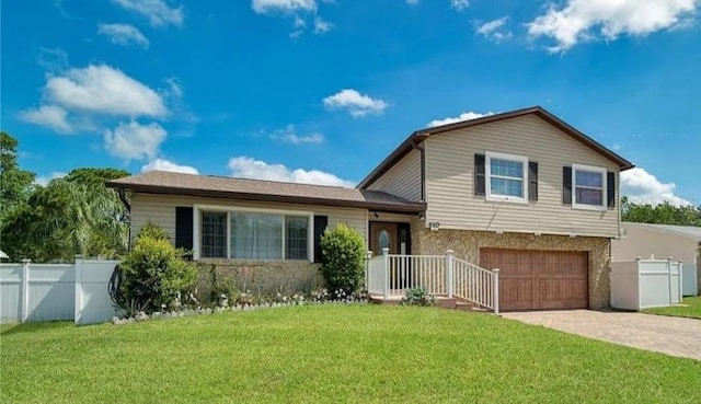 split level home featuring a front yard and a garage