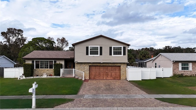 split level home with a front yard and a garage