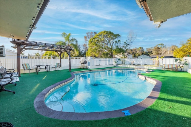 view of pool with a yard and a pergola