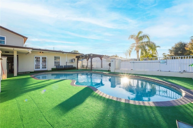 view of pool with a pergola, a lawn, and french doors