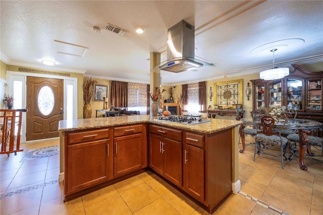 kitchen featuring ornamental molding, island range hood, stainless steel gas cooktop, and light tile patterned floors