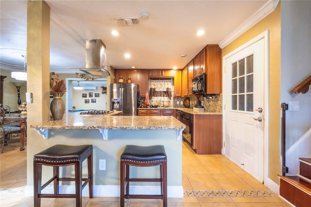 kitchen with black appliances, backsplash, island exhaust hood, light tile patterned floors, and kitchen peninsula