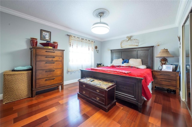 bedroom with crown molding, dark hardwood / wood-style floors, and a textured ceiling