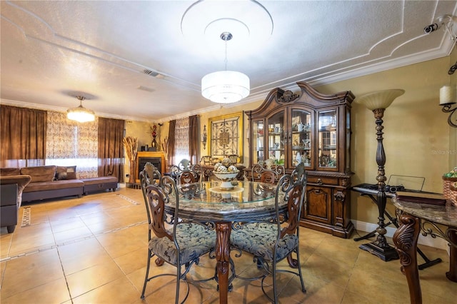 dining area with ornamental molding and light tile patterned floors