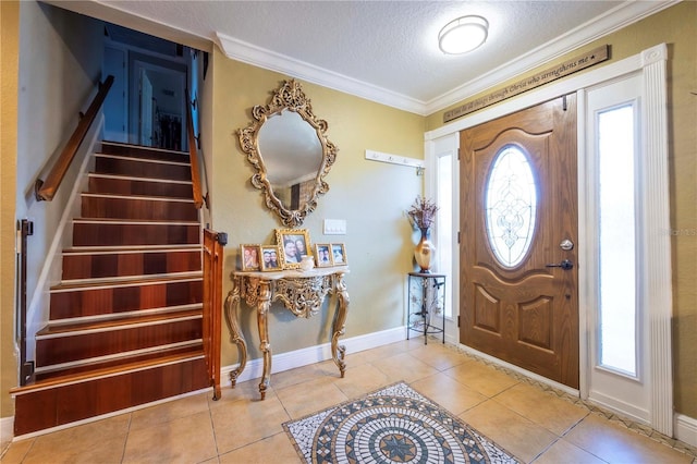 tiled foyer featuring crown molding and a textured ceiling