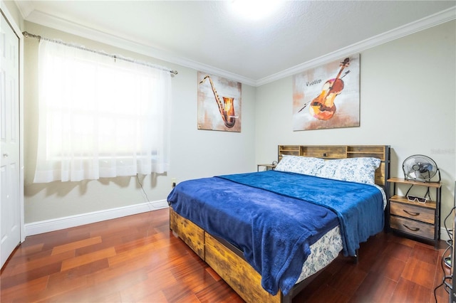 bedroom with crown molding and dark hardwood / wood-style floors