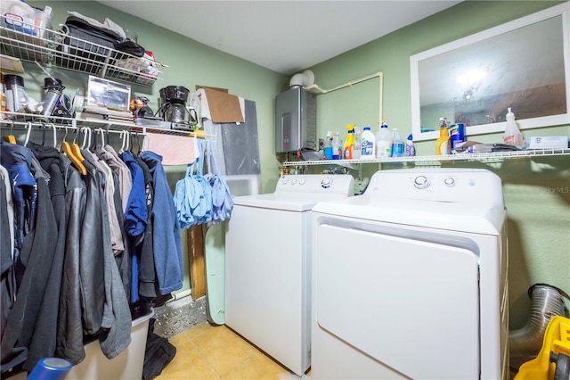 clothes washing area with light tile patterned floors and independent washer and dryer