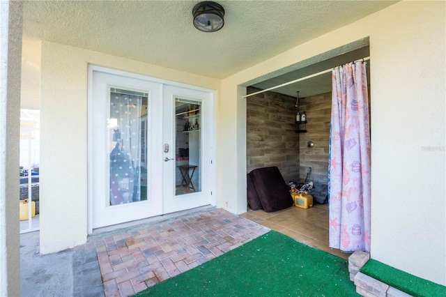 entrance to property with a patio and french doors