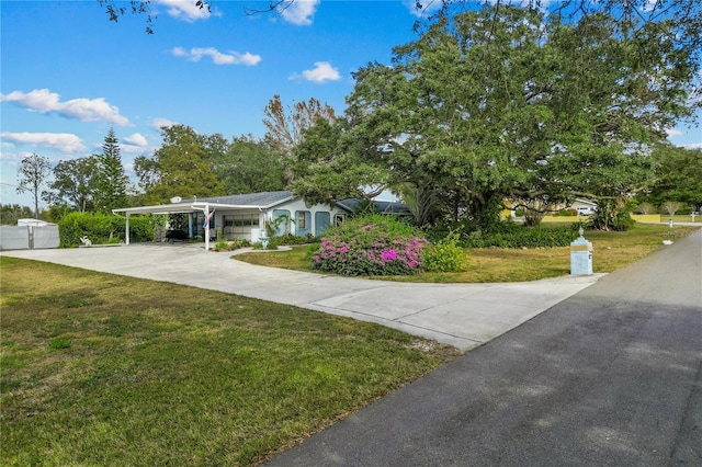 view of front facade with a front lawn and a carport