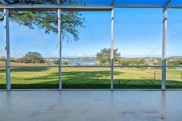 unfurnished sunroom featuring a water view