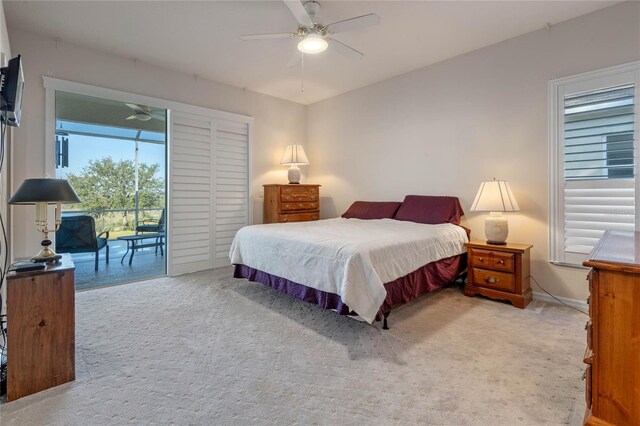 bedroom featuring access to outside, light colored carpet, and ceiling fan