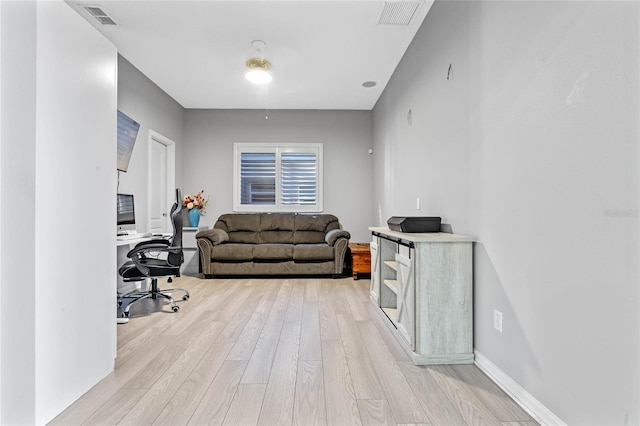 office space with light wood-type flooring