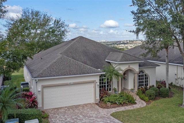 view of front of house with a front lawn and a garage