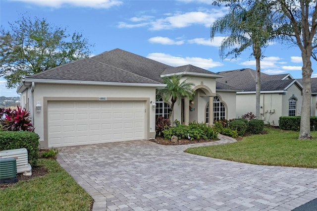 view of front of house featuring a front yard and a garage