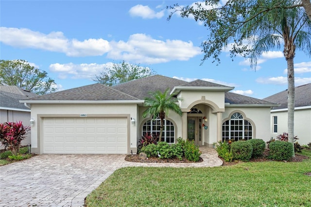 view of front of house with a front yard and a garage