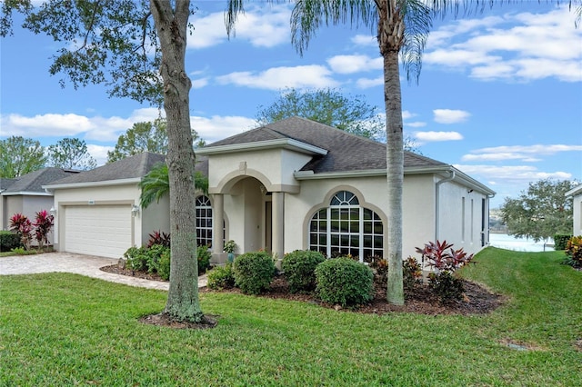 mediterranean / spanish-style house with a garage and a front yard