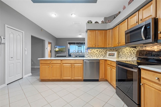 kitchen featuring sink, stainless steel appliances, backsplash, kitchen peninsula, and light tile patterned flooring