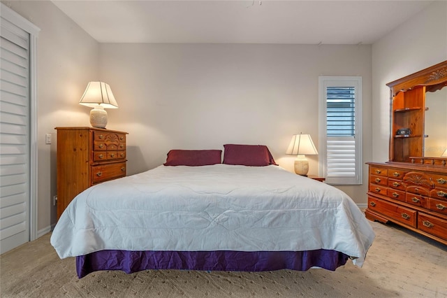 bedroom featuring light carpet