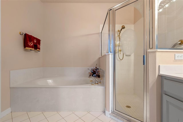 bathroom with tile patterned flooring, vanity, and separate shower and tub