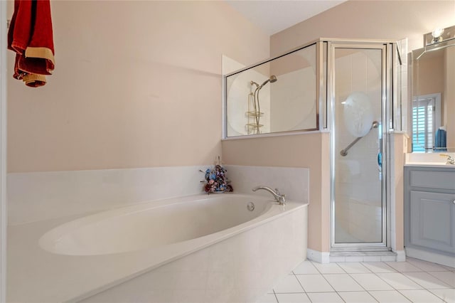 bathroom featuring plus walk in shower, tile patterned flooring, and vanity