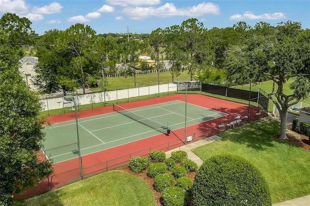 view of tennis court with a lawn