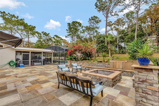 view of patio featuring glass enclosure, an outdoor living space with a fire pit, and a sunroom