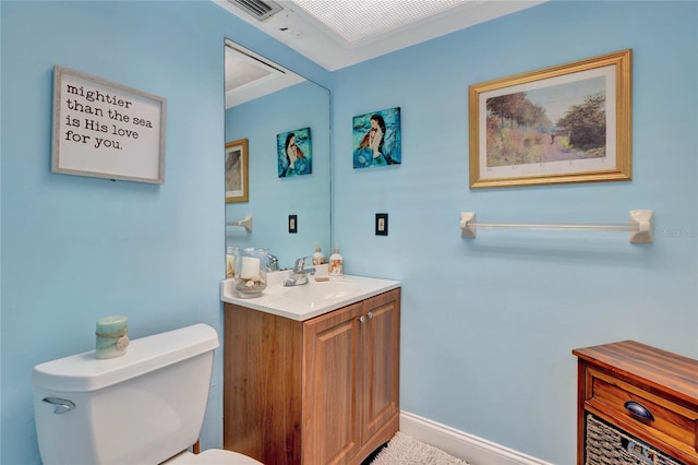 bathroom featuring vanity, ornamental molding, and toilet