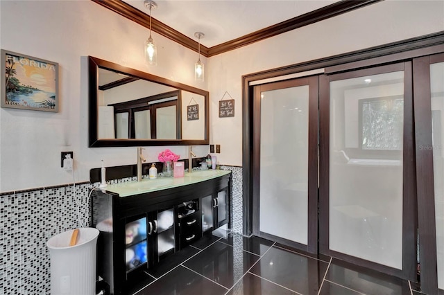 bathroom with ornamental molding, vanity, tile walls, tile patterned flooring, and a tub