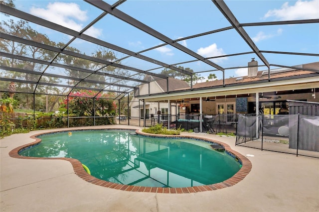 view of pool featuring ceiling fan, a patio area, and glass enclosure