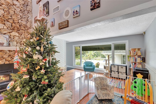 living area featuring a textured ceiling and hardwood / wood-style flooring