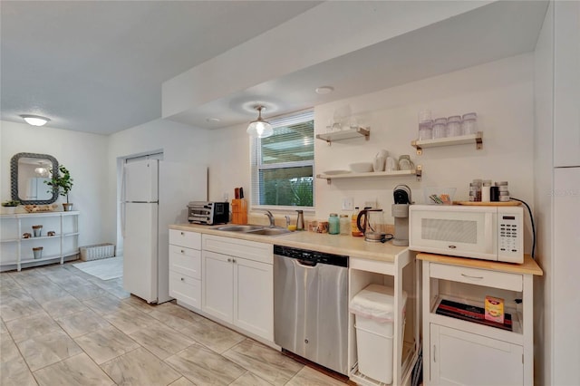 kitchen featuring white cabinetry, white appliances, and sink